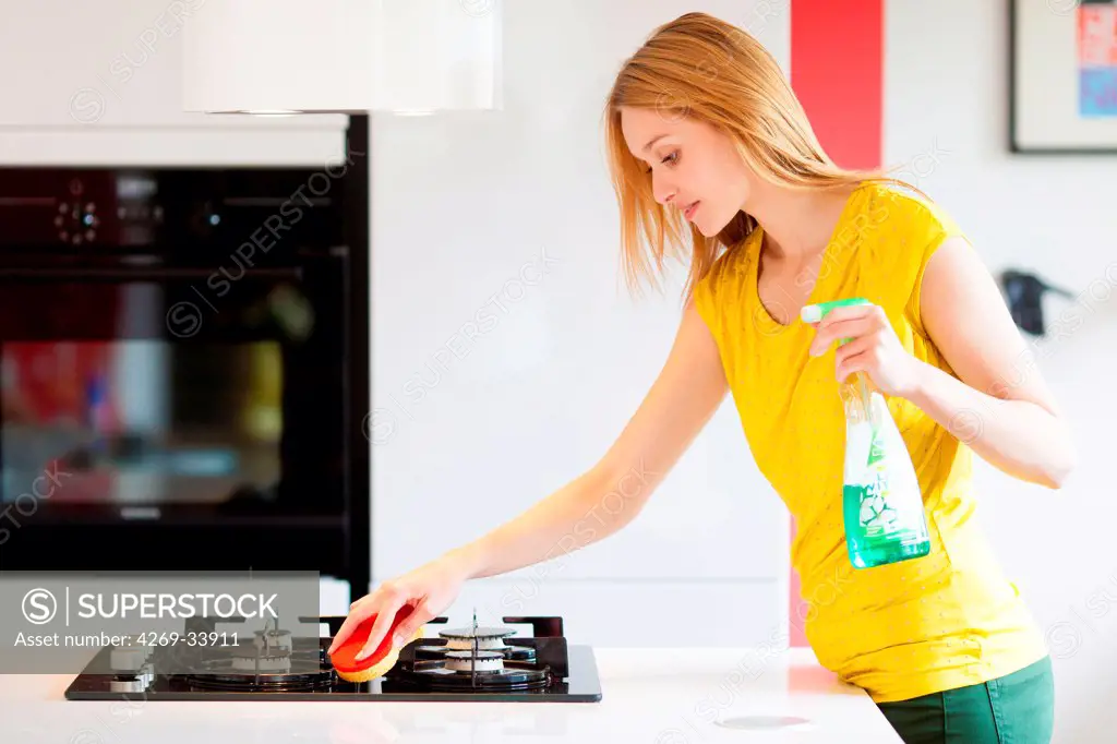 Woman housecleaning in the kitchen.