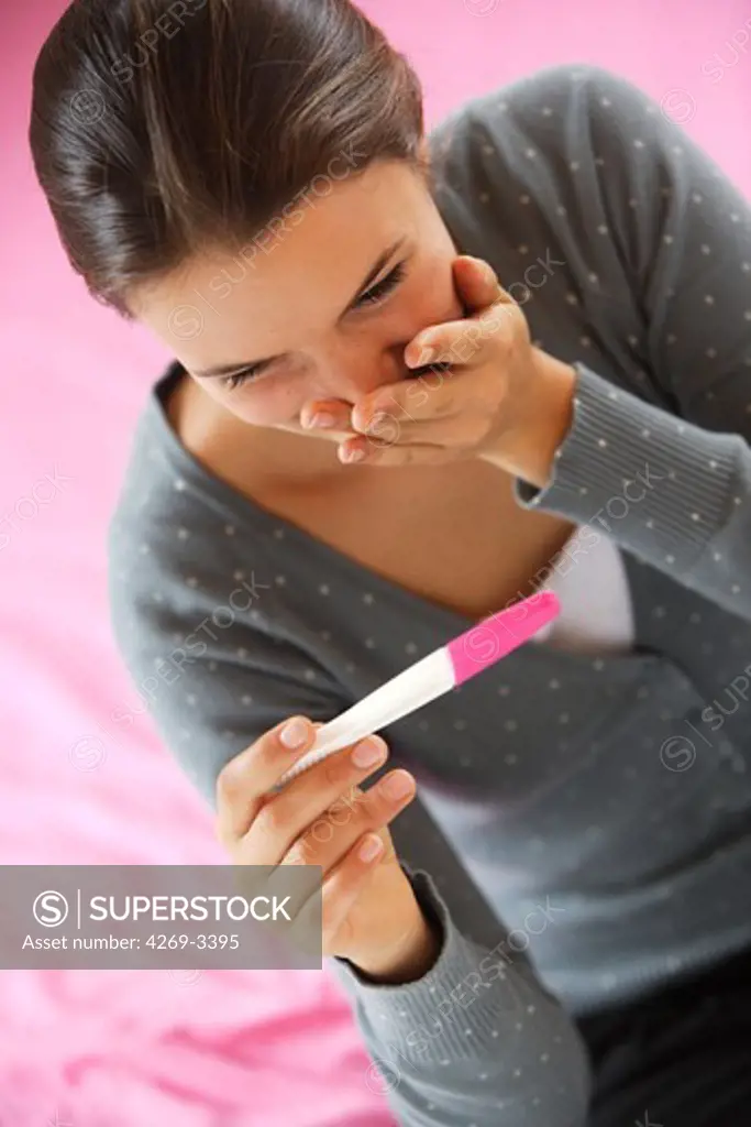Woman checking the results of a pregnancy test.