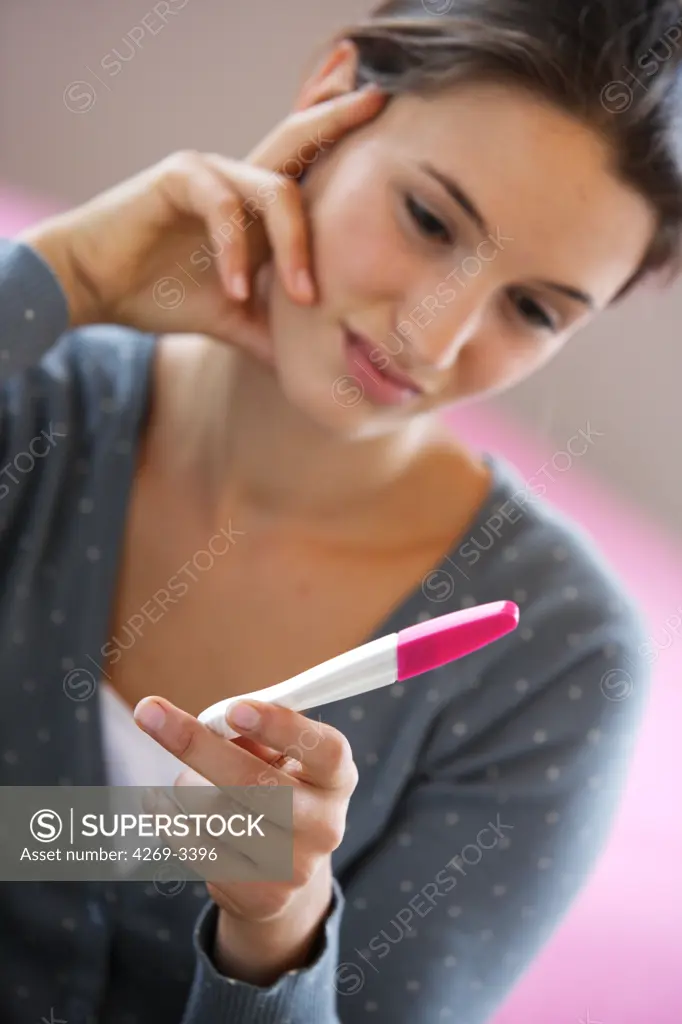 Woman checking the results of a pregnancy test.