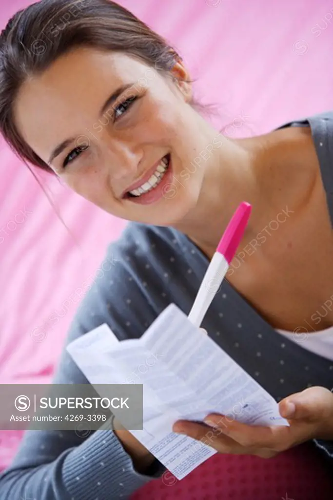 Woman checking the results of a pregnancy test.
