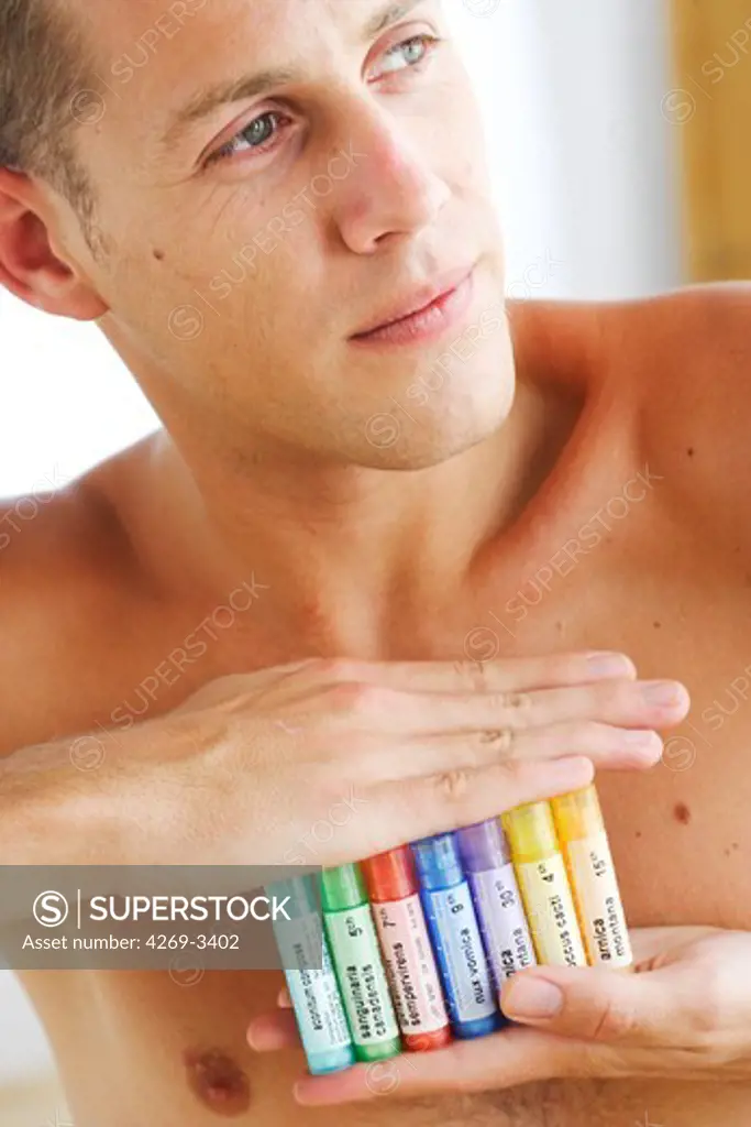 Man holding homeopathic medicine.