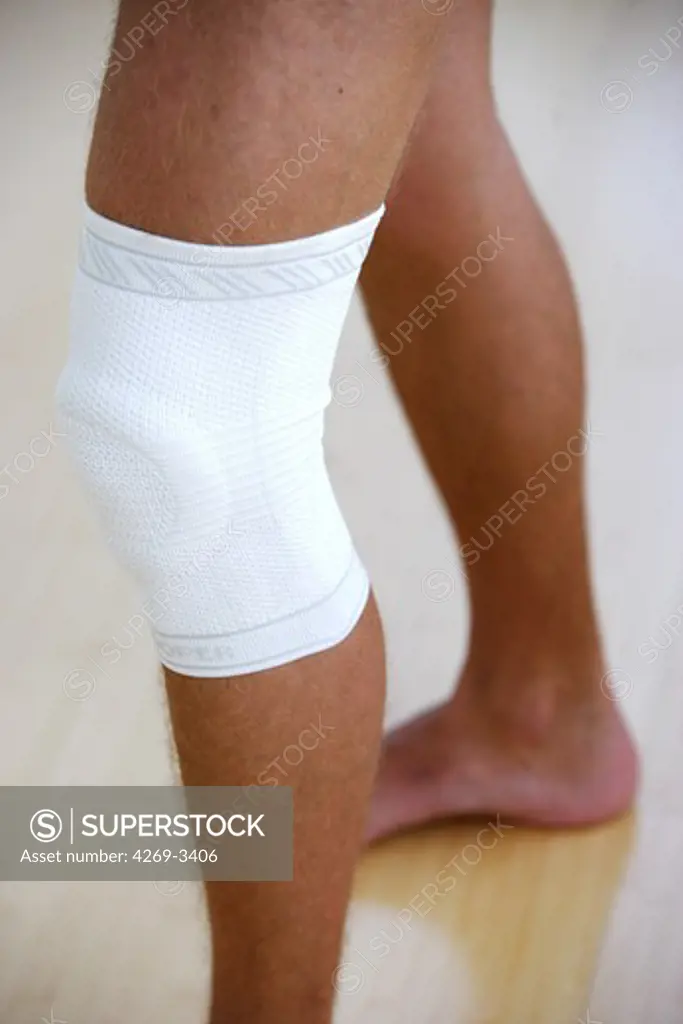 Man wearing a knee support.