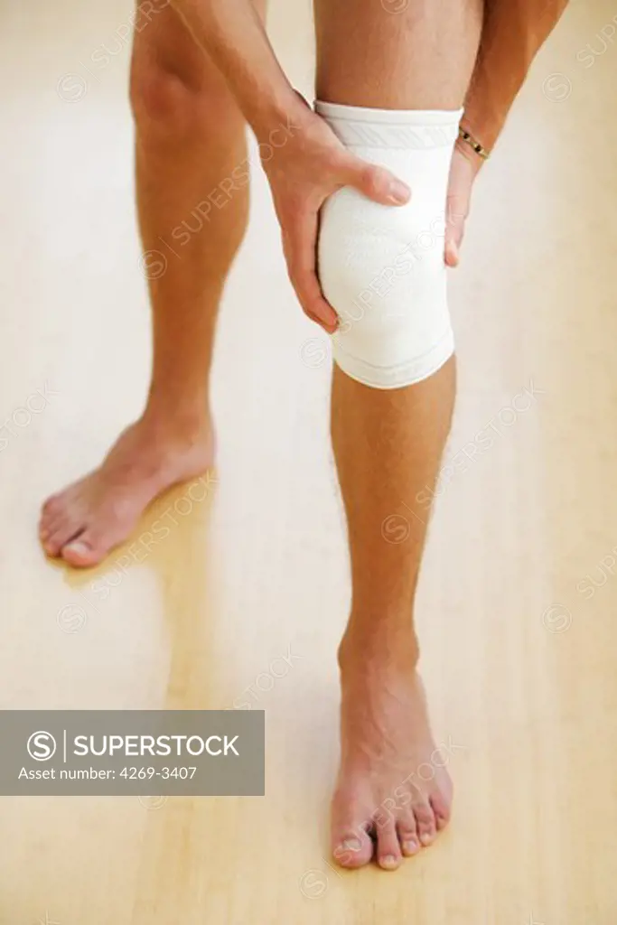Man wearing a knee support.