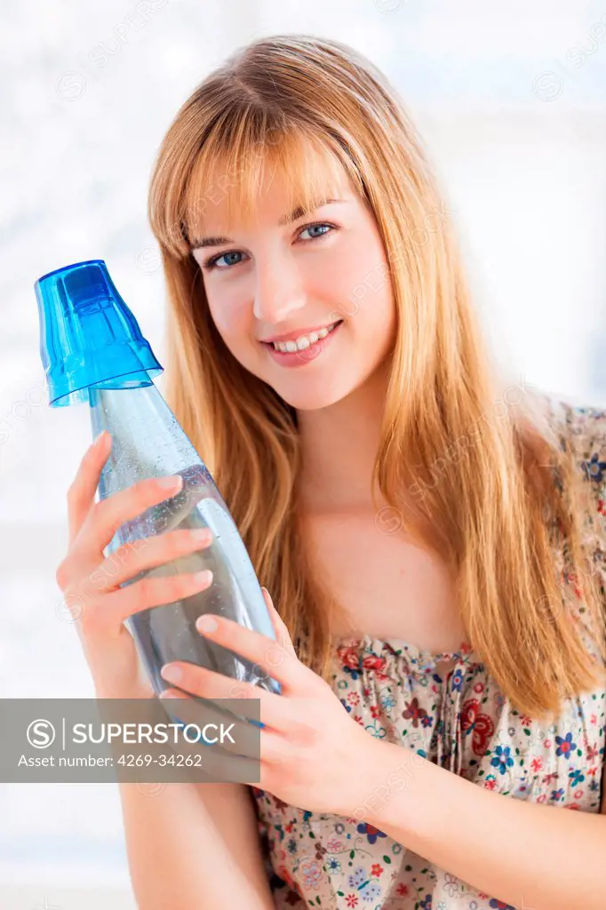 Woman drinking mineral gas water.