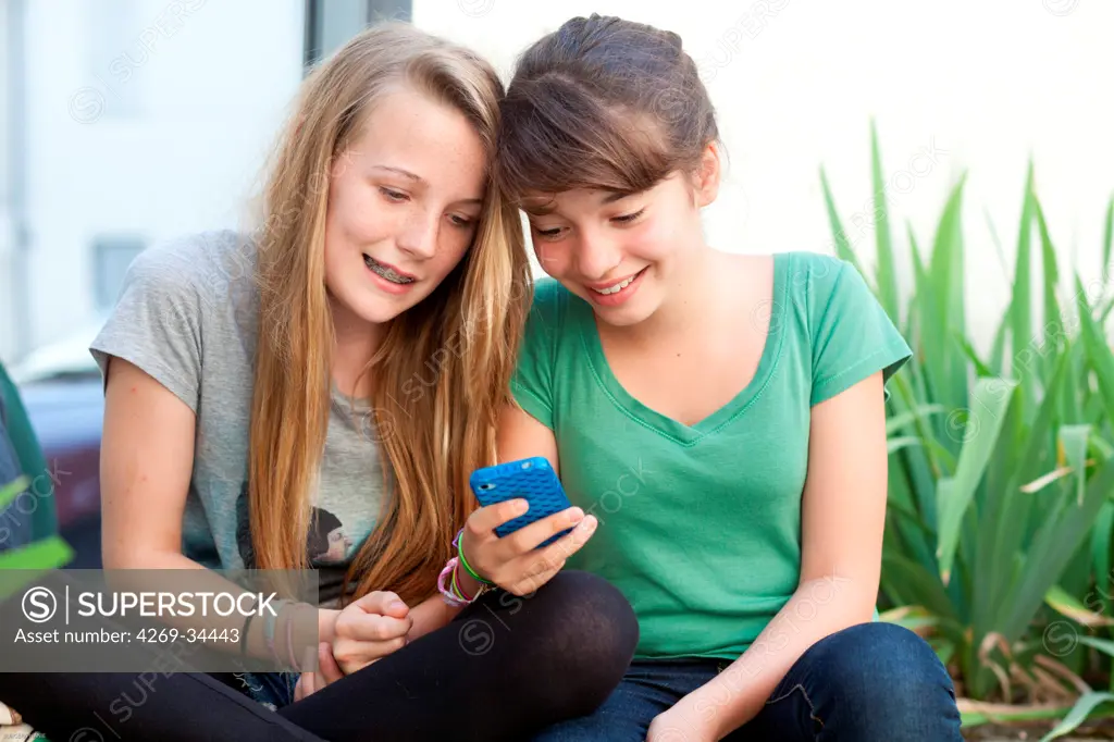 Teenage girls using a mobile phone.