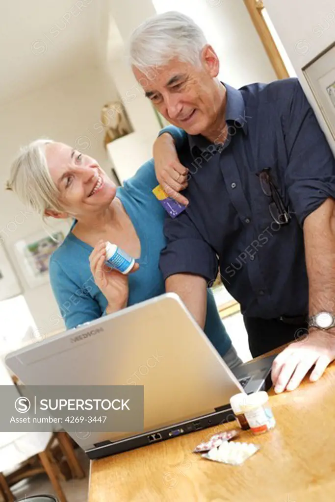 Senior couple purchasing medications on the internet.