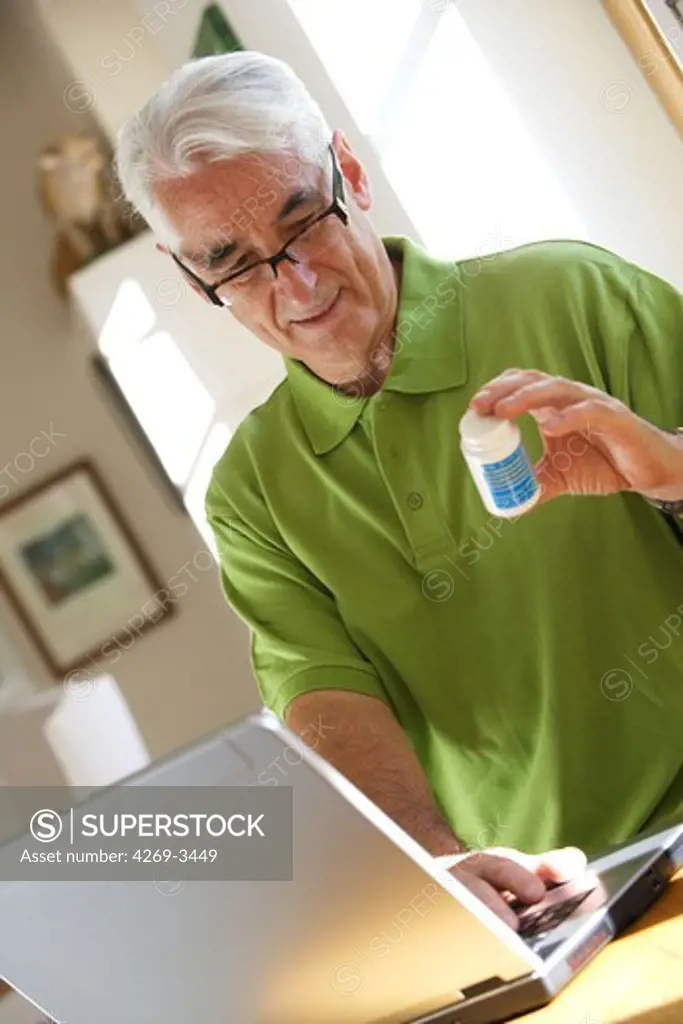 Senior man purchasing drugs on the internet.