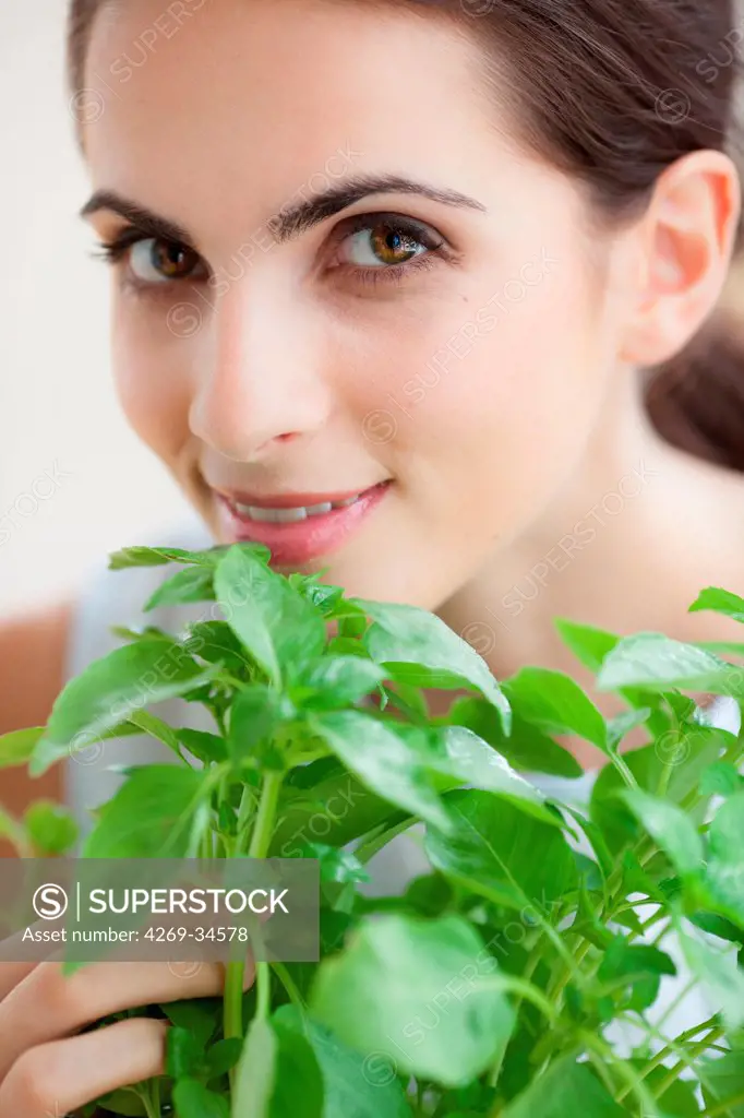 Woman smelling basil.