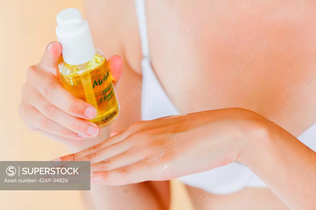 Woman using sweet almond oil.