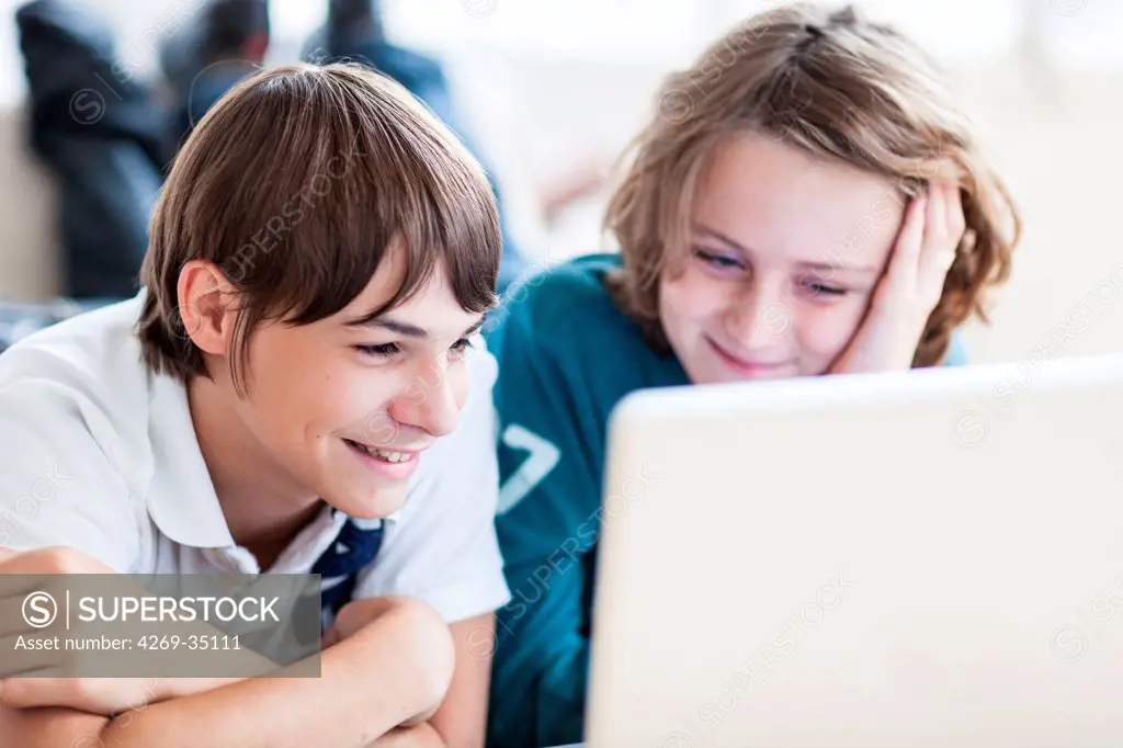 Teenagers using laptop