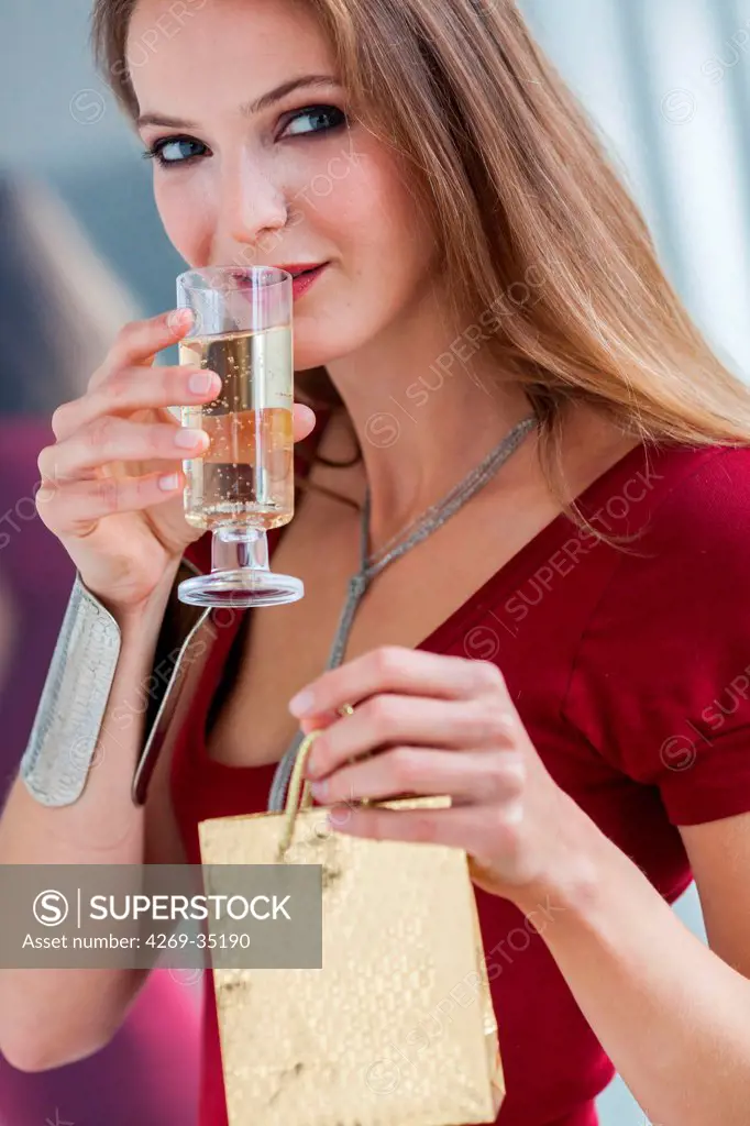 Woman drinking champagne and gift