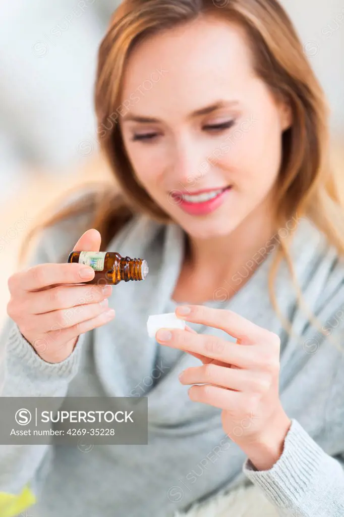 Woman applying essential oil on sugar