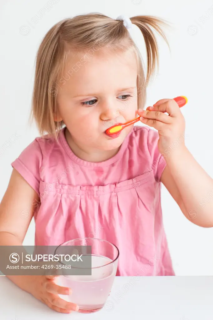 2 years old girl brushing her teeth