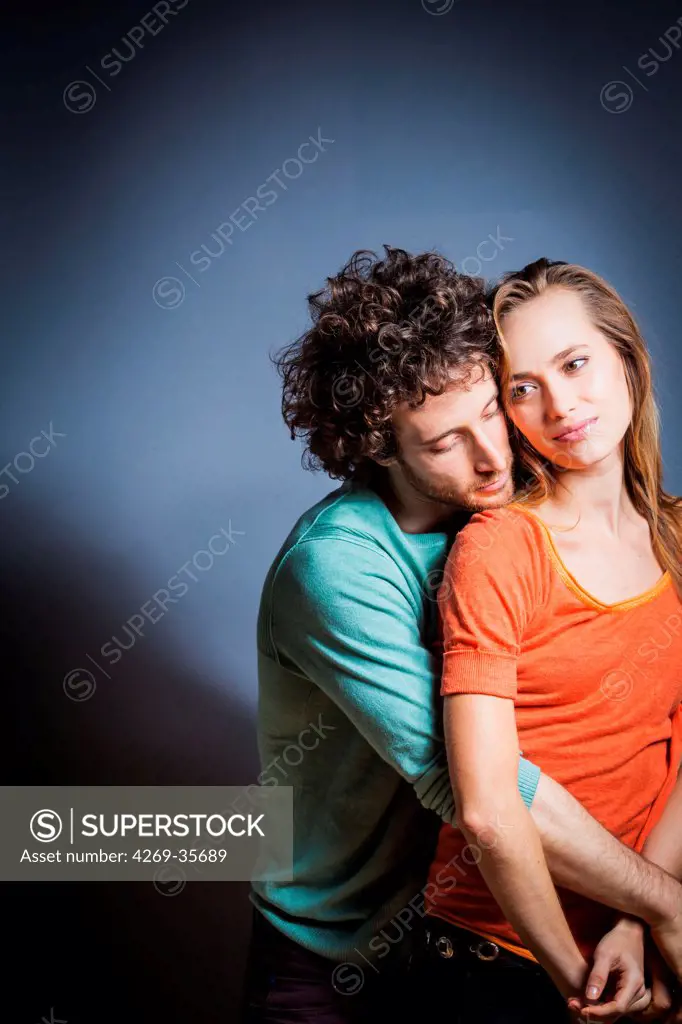 Couple hugging indoors