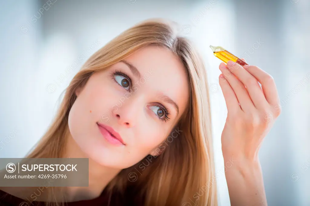 Woman applying hair lotion
