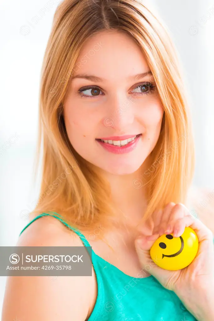 Woman kneading a smiley stress ball