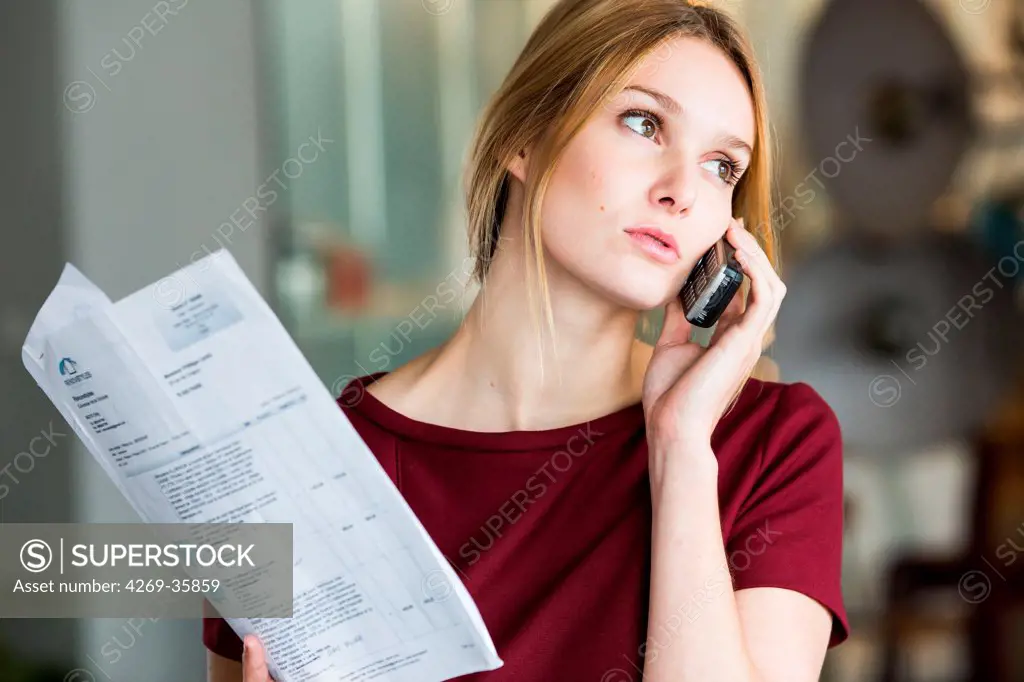 Woman on the phone with administrative papers