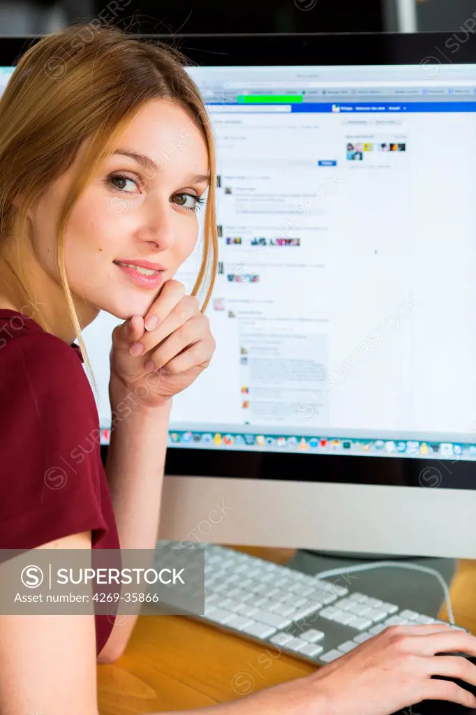 Woman using the web site Facebook