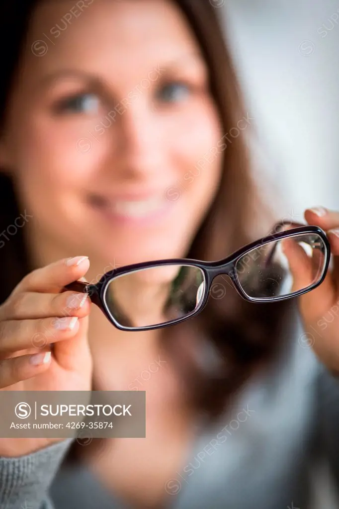 Woman holding glasses