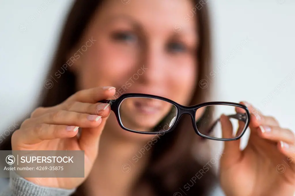 Woman holding glasses
