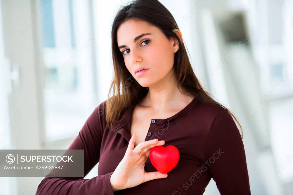 Woman holding a plastic heart