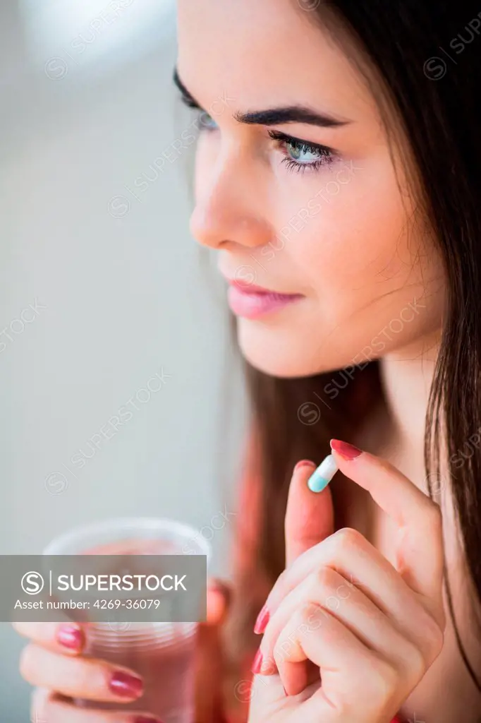 Woman taking gelatine capsule medication