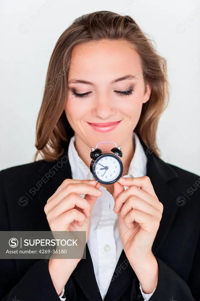 Woman holding an alarm clock