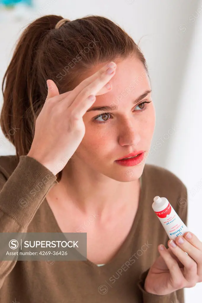 Woman using arnica ointment