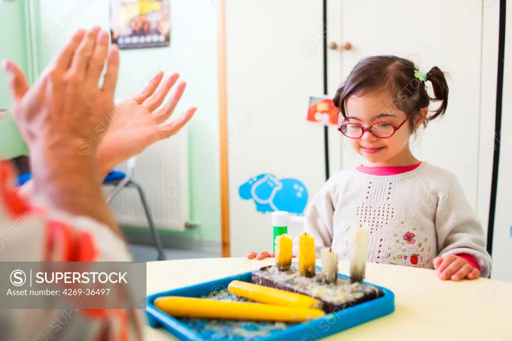 4 year old girl Down's syndrome during a session with a special education teacher.