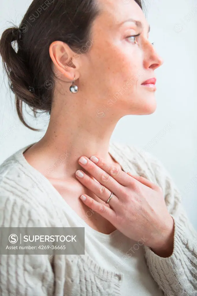 Woman self-examining her throat