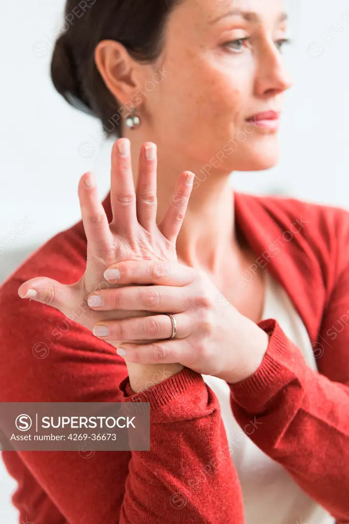Woman giving herself a hand massage