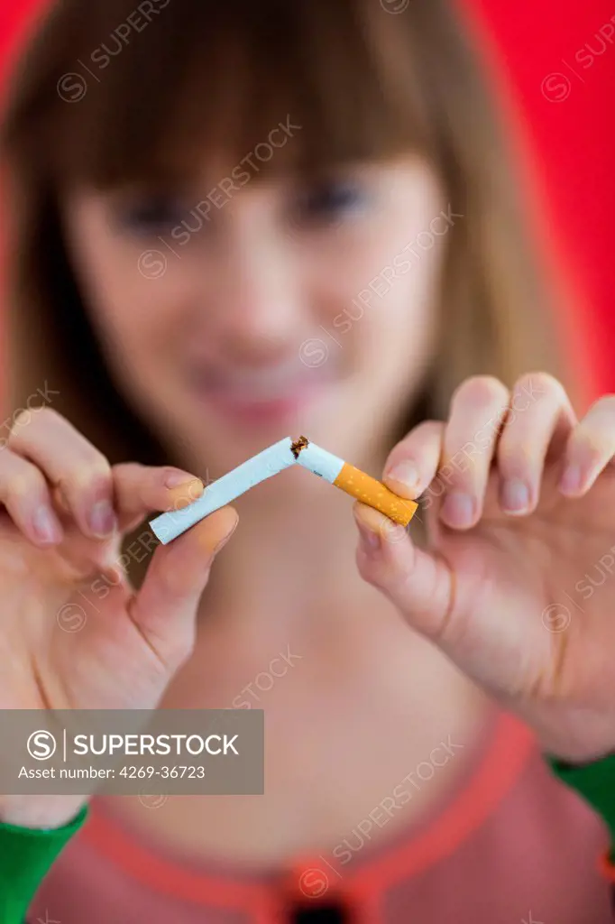 Woman snapping a cigarette in half