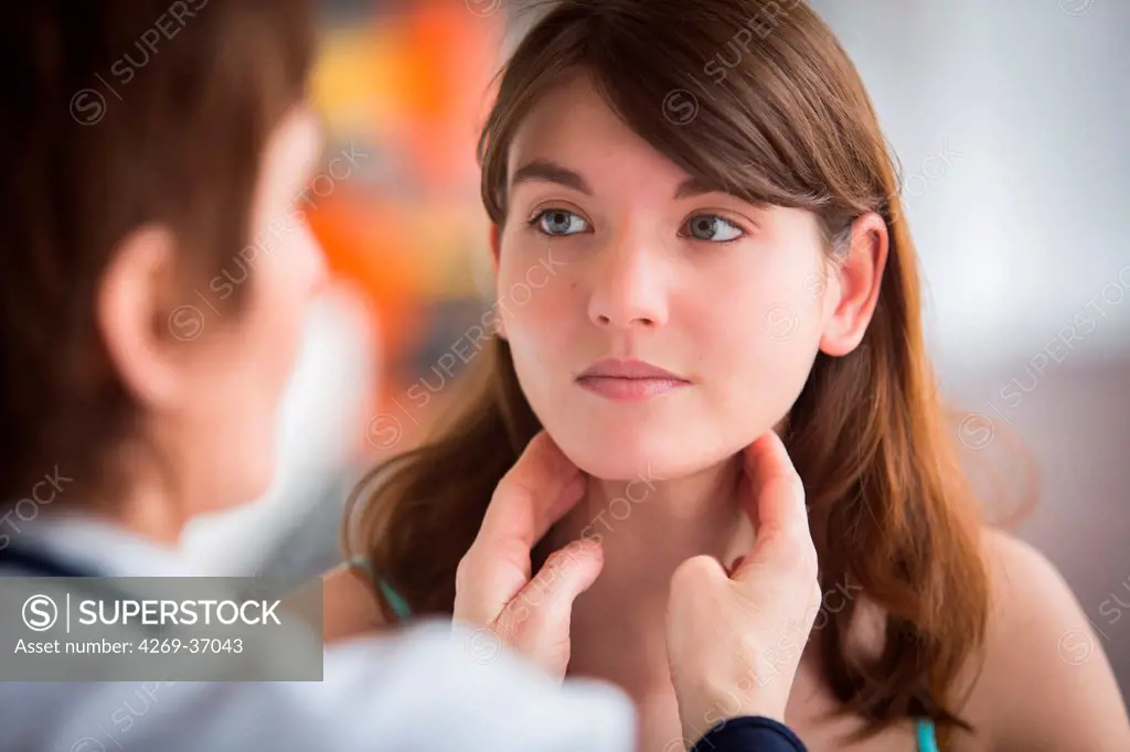 Medical consultation, General practitioner palpating the lymphatic glands of a patient during medical consultation.
