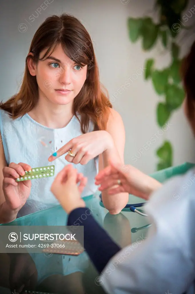 Medical consultation, Doctor talking with a female patient.