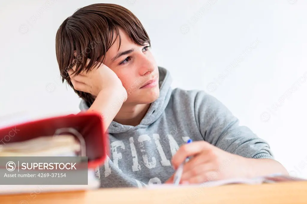 Teenager, Teenage boy doing homework.