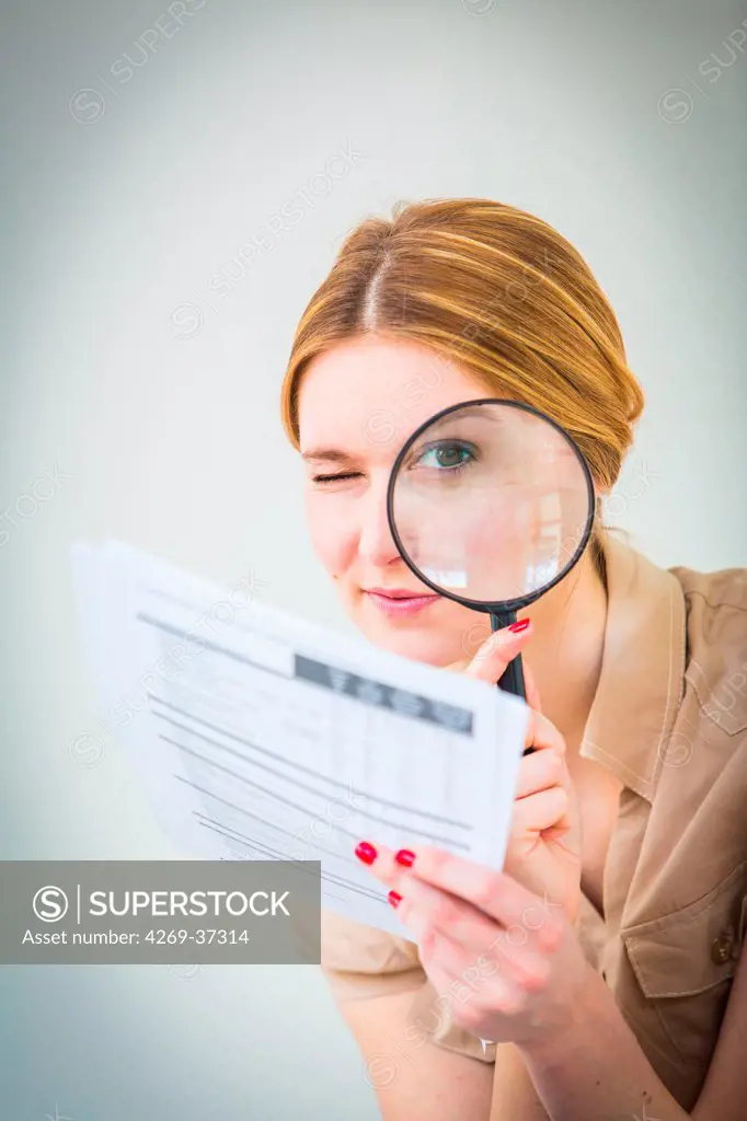 Woman using a magnifying glass.