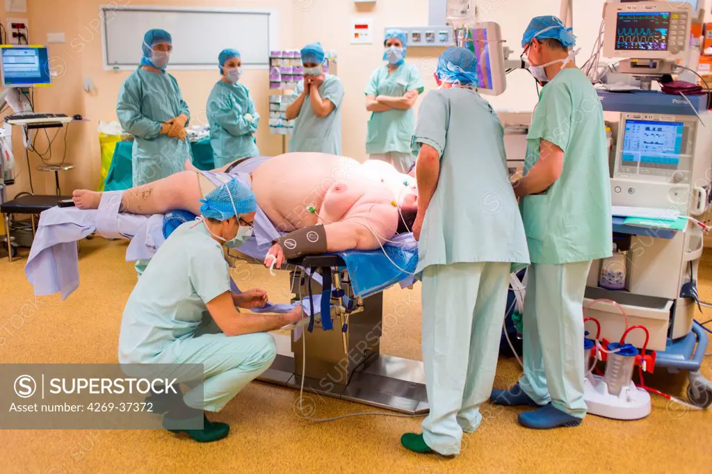 Operating theatre team preparing an obese female patient prior to Laparoscopic Sleeve Gastrectomy, Limoges hospital.