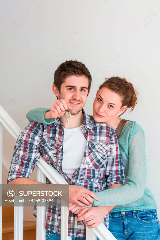 Young couple holding new house keys.