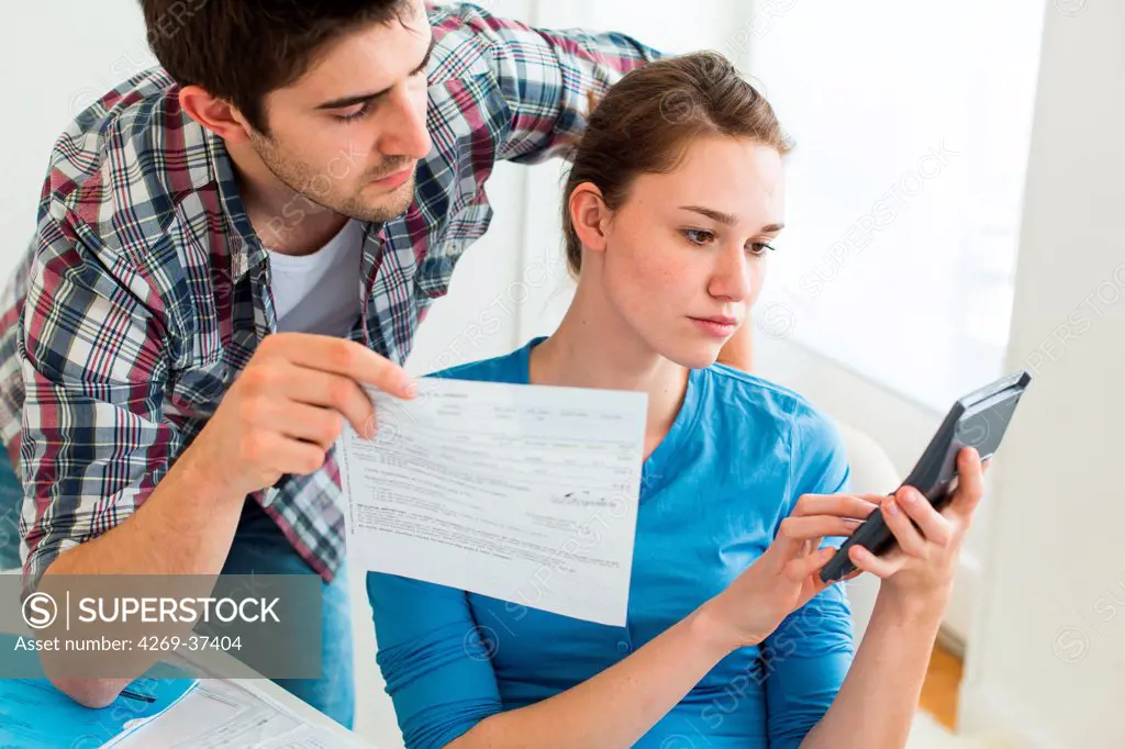 Young couple doing paperwork together.