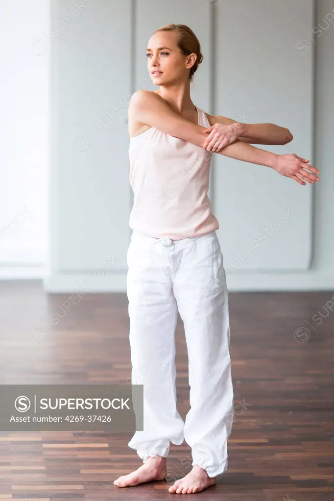 Woman practicing stretching exercises to relieve back pain.