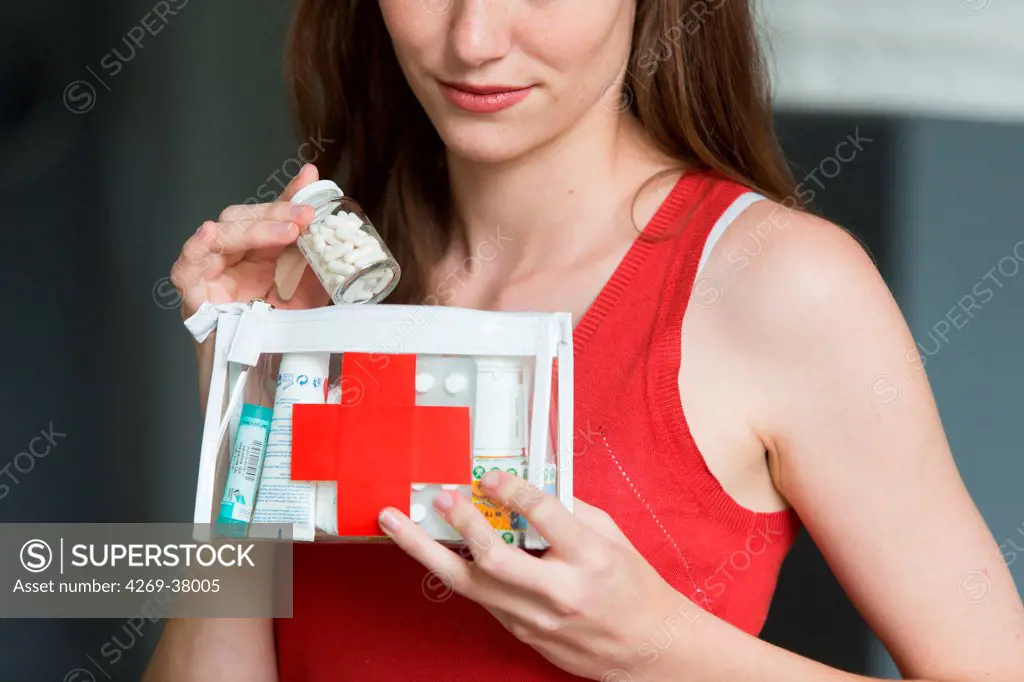 Woman holding a clear first aid kit.