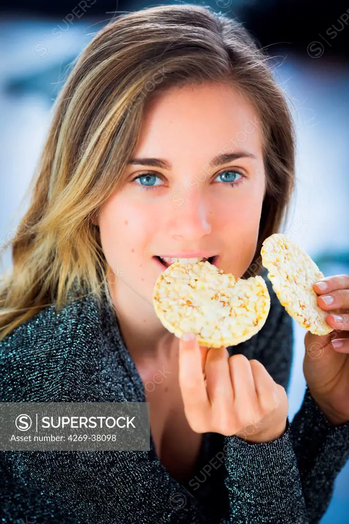 Woman eating a popcorn galette.
