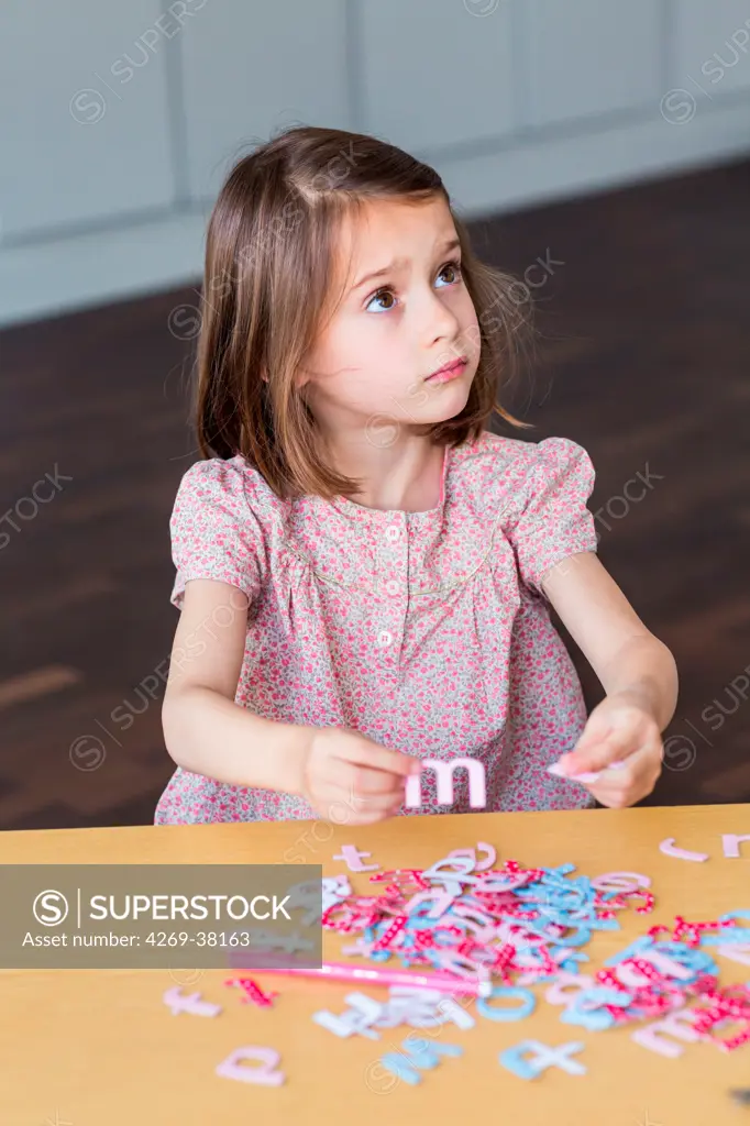 5 year old girl doing manual activity.