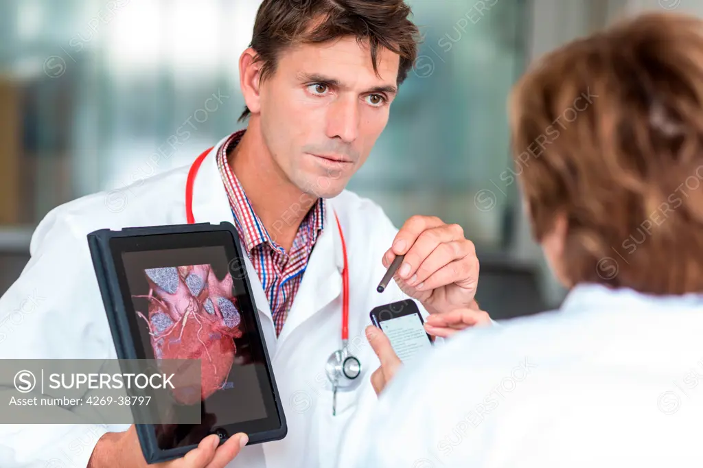 Doctors using a tablet PC and Iphone®.