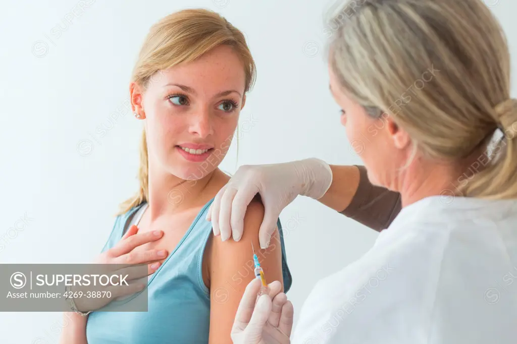 Young woman receiving vaccination.