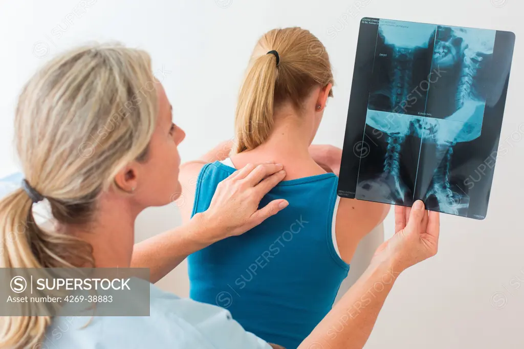 Doctor looking at a of the cervical spine x-ray of her patient.