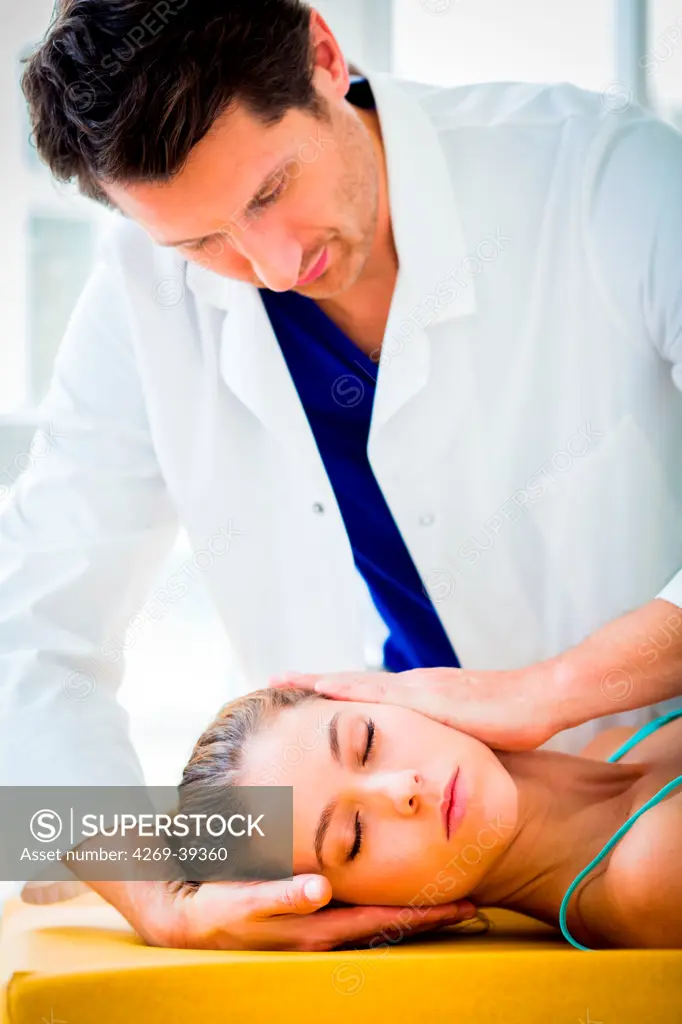 Woman's head being manipulated by an osteopath.