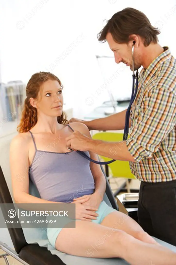 General practitioner examining a patient with a stethoscope.