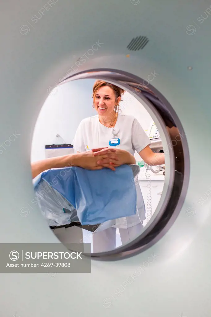 Female patient undergoing a CT scan, Angoulême hospital, France .