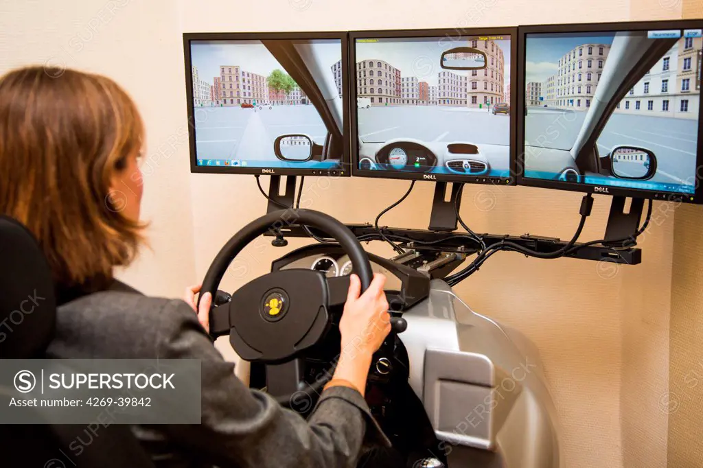 Woman driving during a session of virtual reality therapy with a driving simulator to treat amoxophobia or phobia of driving. Department of Psychiatry, Pitie-Salpetriere hospital, Paris, France.